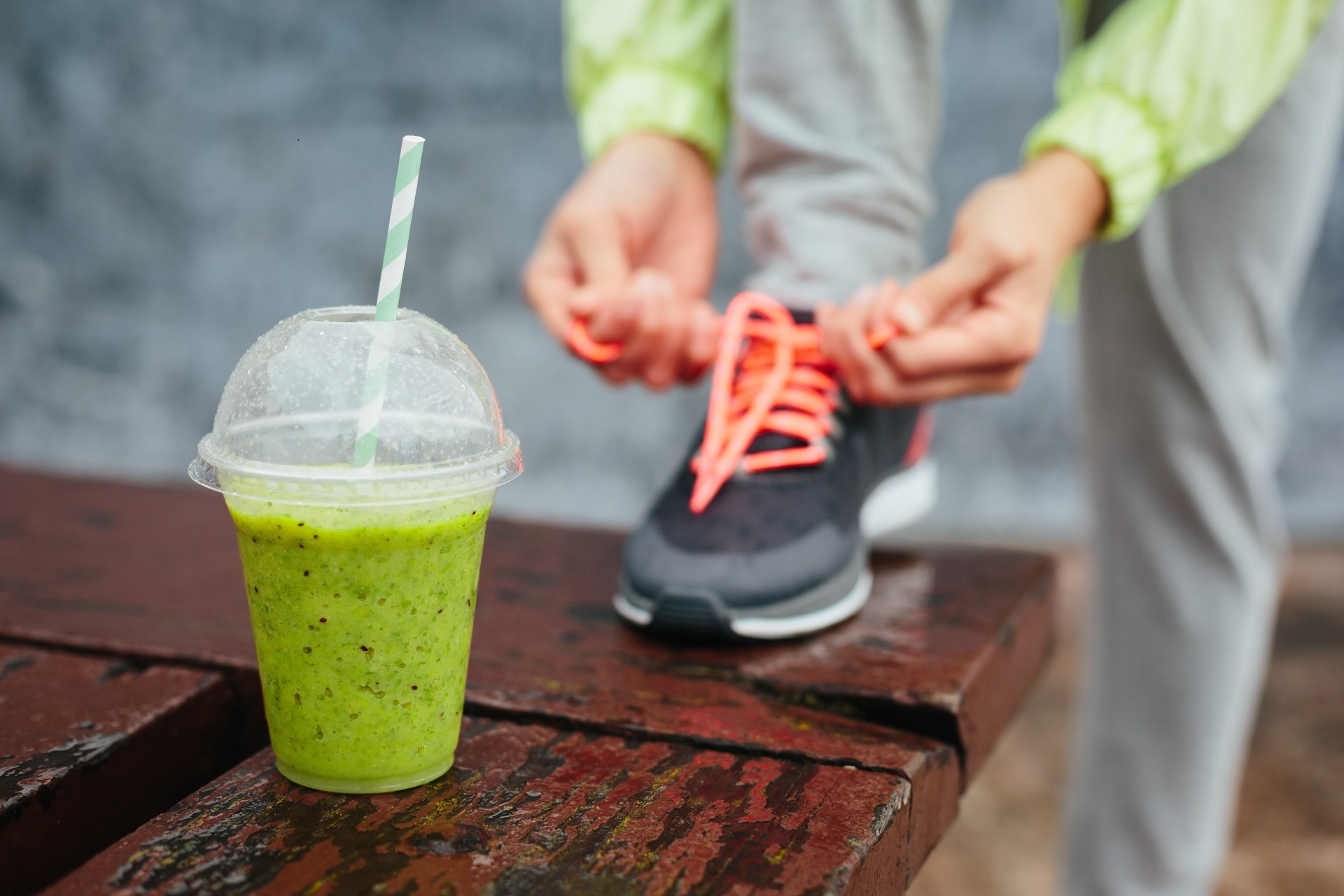 Green-Detox-Smoothie-Cup-And-Woman-Lacing-Running-Shoes-Before